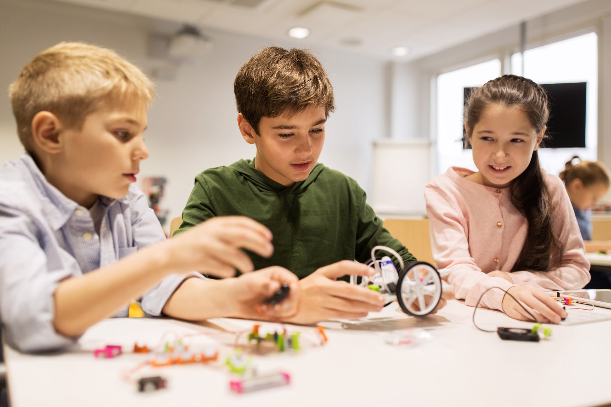 happy children building robots at robotics school Montessori Academy of Cincinnati